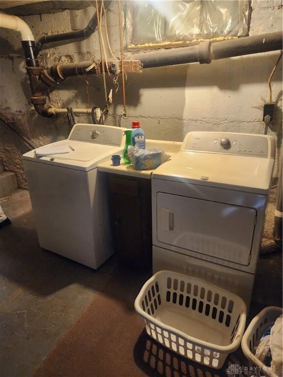 clothes washing area featuring washer and clothes dryer