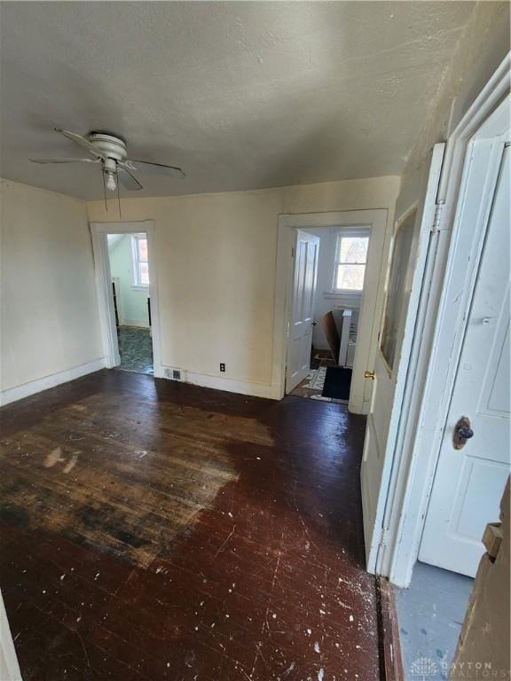 unfurnished room featuring ceiling fan and dark hardwood / wood-style floors