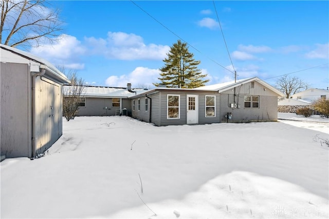 view of snow covered back of property