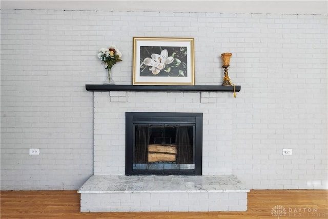 details featuring a fireplace and hardwood / wood-style flooring