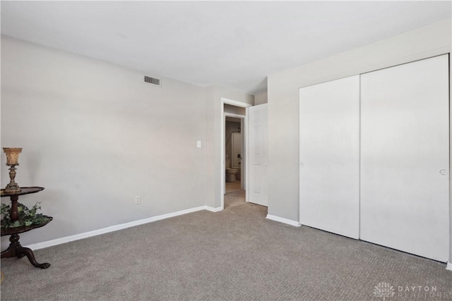 unfurnished bedroom featuring a closet and carpet floors