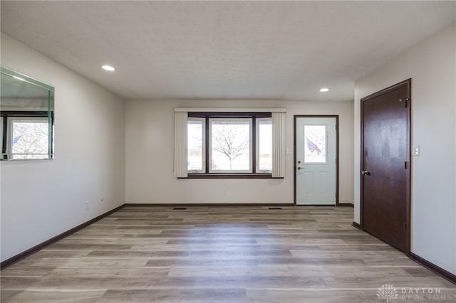 entryway featuring light hardwood / wood-style flooring and a textured ceiling