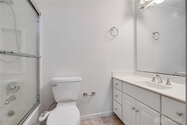 full bathroom featuring combined bath / shower with glass door, tile patterned floors, vanity, crown molding, and toilet