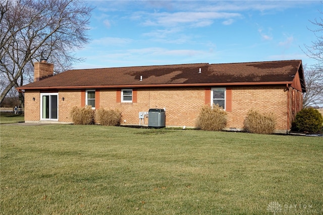 back of house with a yard and cooling unit