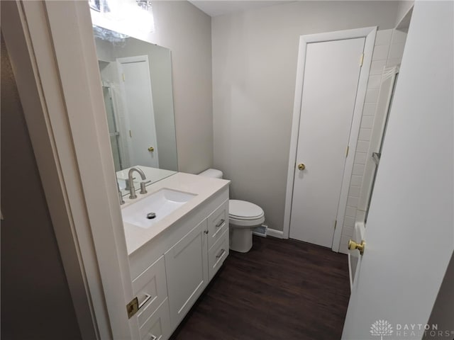 bathroom with vanity, toilet, wood-type flooring, and walk in shower