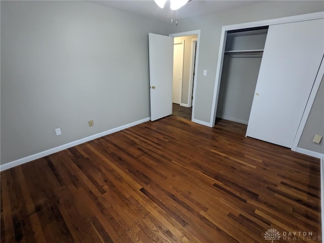 unfurnished bedroom with dark hardwood / wood-style floors and a closet