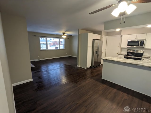 kitchen featuring stainless steel appliances, white cabinetry, dark hardwood / wood-style floors, and ceiling fan