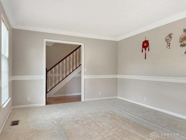 empty room featuring a healthy amount of sunlight and crown molding