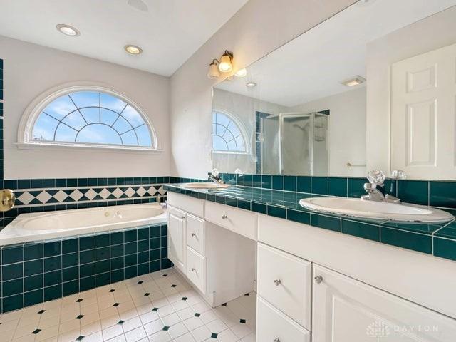 bathroom with tile patterned flooring, vanity, and shower with separate bathtub