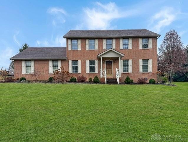 colonial-style house with a front lawn