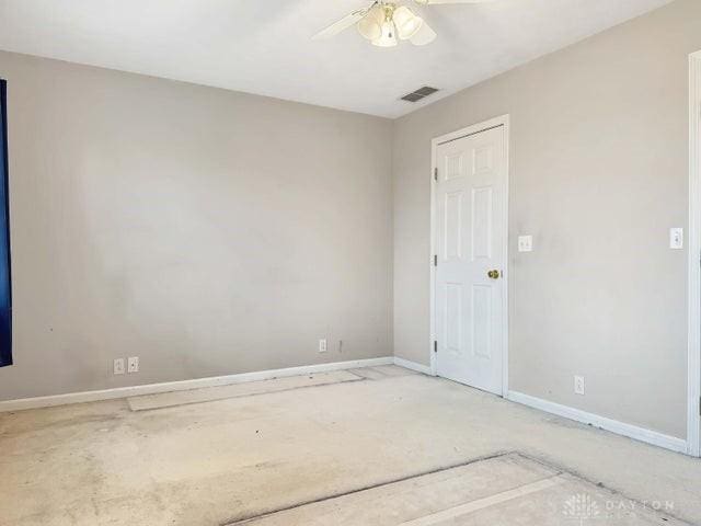 empty room with carpet and ceiling fan