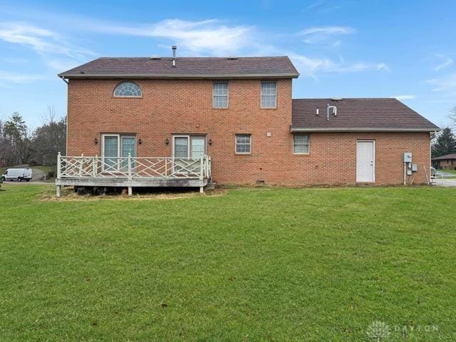 back of house with a yard and a wooden deck