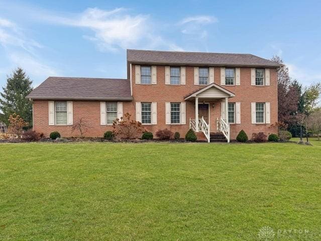 colonial home with a front lawn