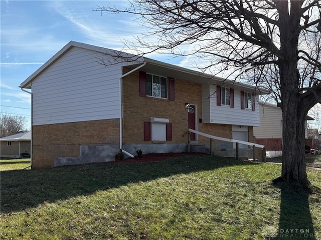 raised ranch with a garage and a front lawn