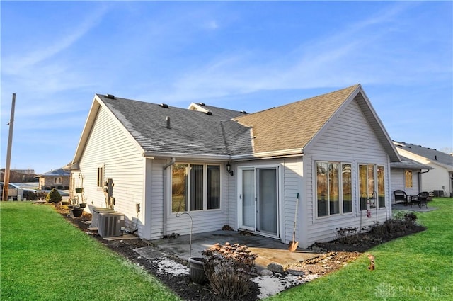 rear view of house with a patio, central air condition unit, and a lawn