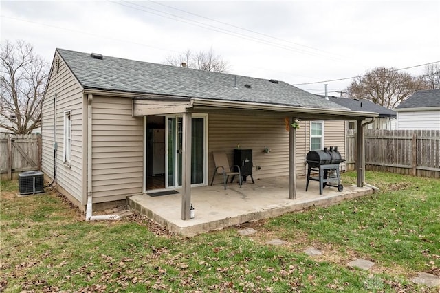 rear view of house with a patio area, a yard, and central AC unit