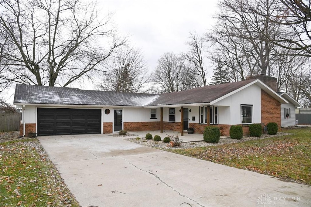 ranch-style home with a porch and a garage