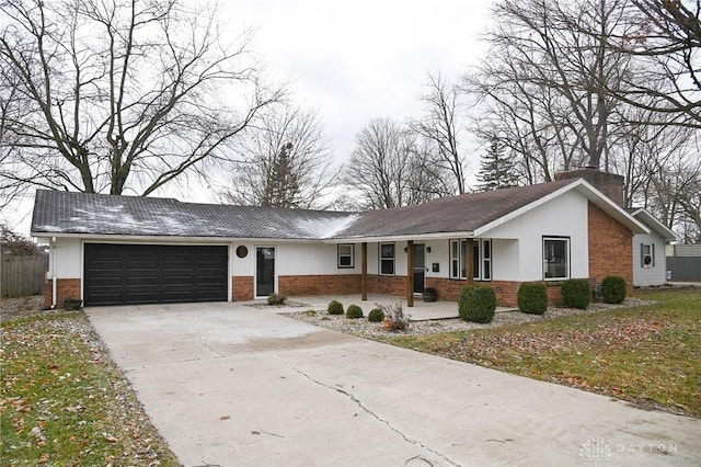 ranch-style home with a porch and a garage