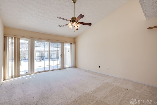 unfurnished room with ceiling fan, a textured ceiling, light carpet, and vaulted ceiling