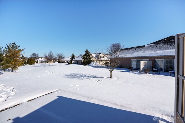 view of yard layered in snow