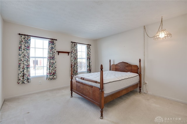 carpeted bedroom featuring a textured ceiling