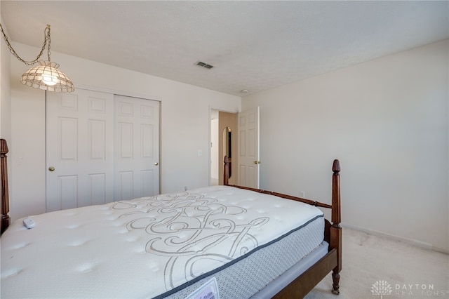 carpeted bedroom with a closet