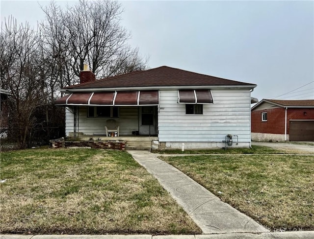 bungalow-style home featuring a front yard