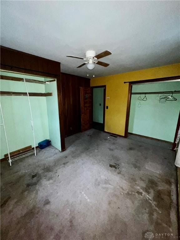 unfurnished bedroom with concrete flooring, a closet, and ceiling fan