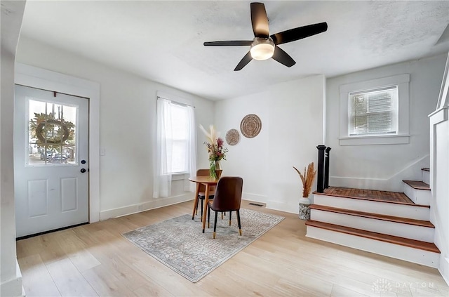 dining room with ceiling fan and light hardwood / wood-style floors