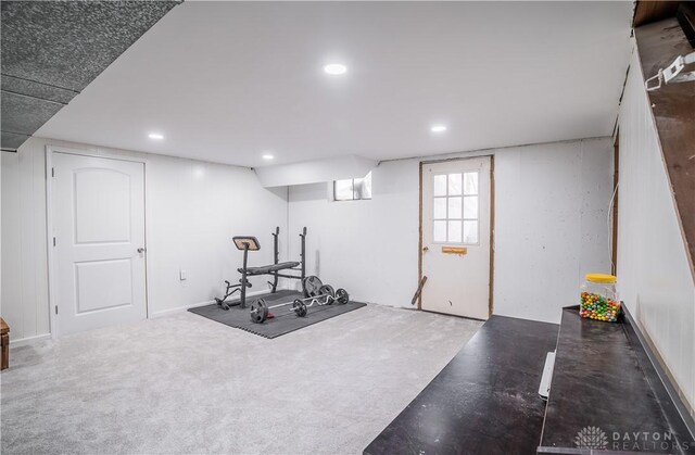 exercise area featuring dark colored carpet