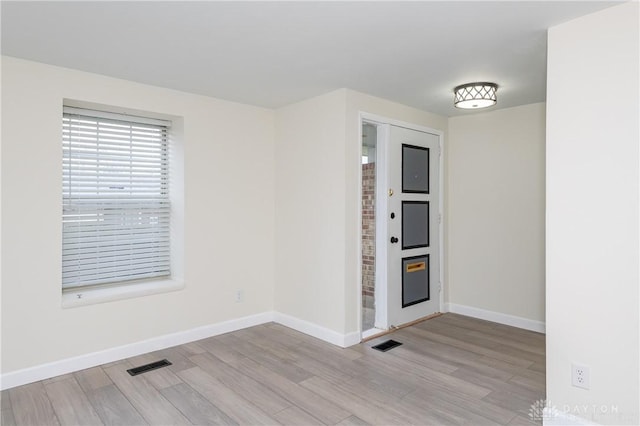 spare room with light hardwood / wood-style flooring