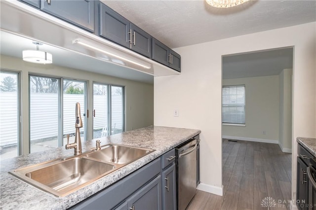 kitchen featuring stainless steel dishwasher, dark wood-type flooring, and sink