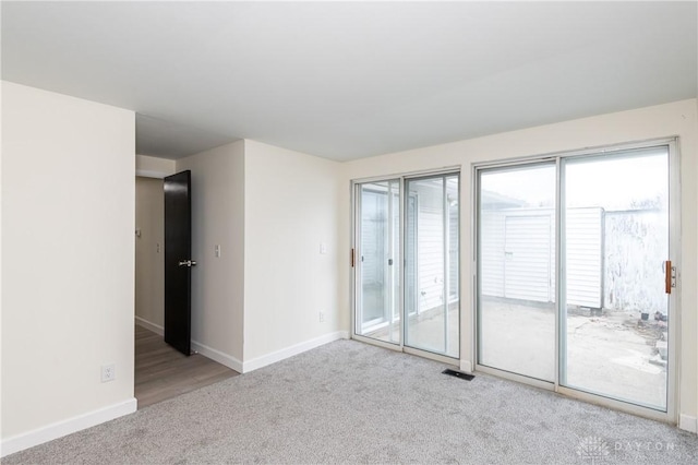 carpeted spare room with plenty of natural light