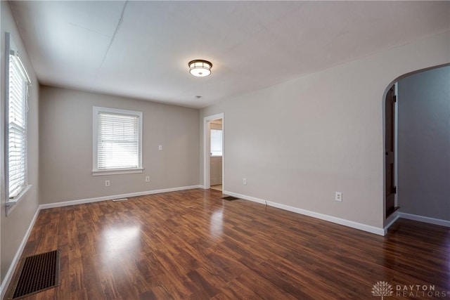 empty room with dark hardwood / wood-style floors