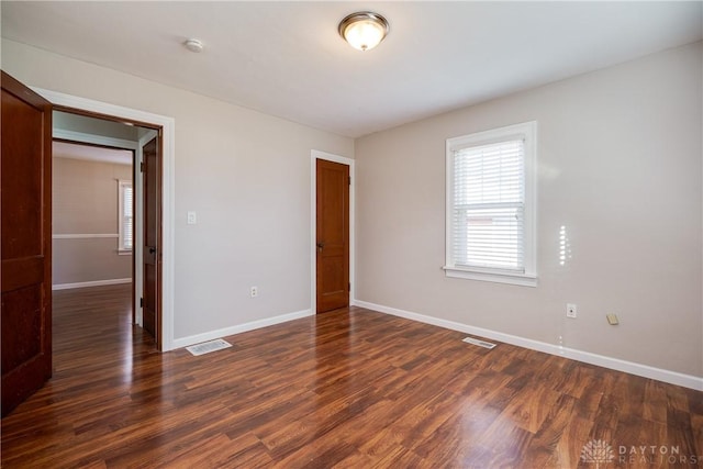 unfurnished bedroom with dark hardwood / wood-style floors and a closet