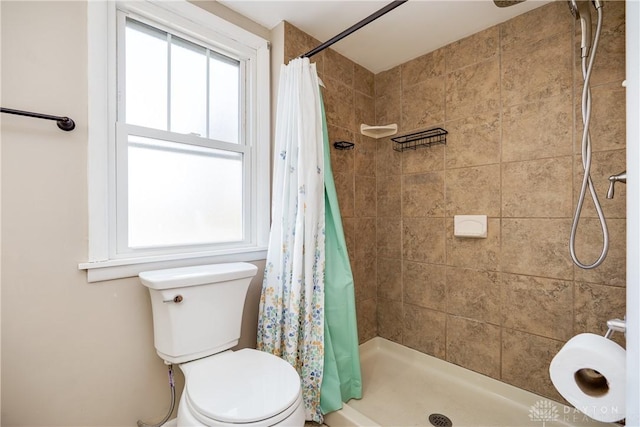 bathroom featuring toilet and a shower with shower curtain