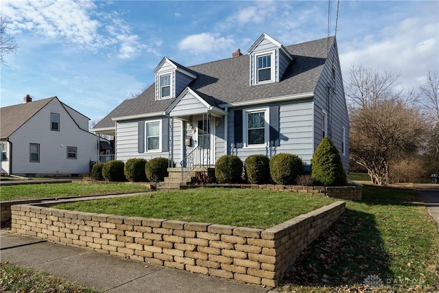 cape cod house featuring a front lawn