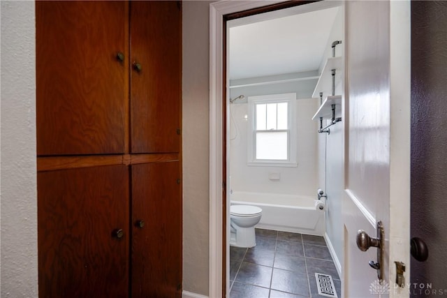 bathroom with tile patterned floors, toilet, and shower / tub combination