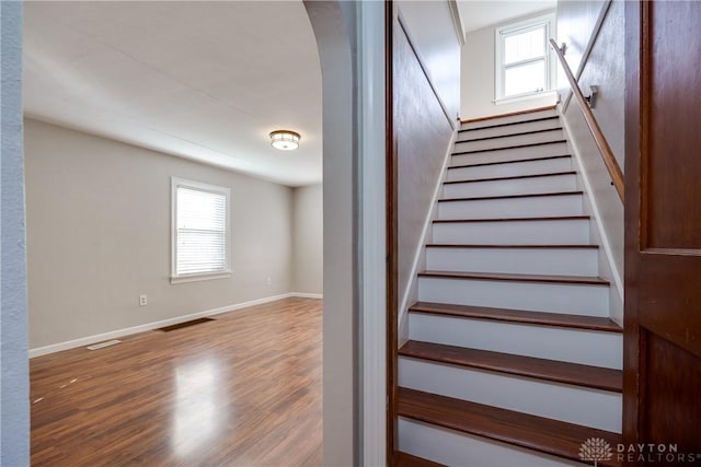 stairway with hardwood / wood-style flooring