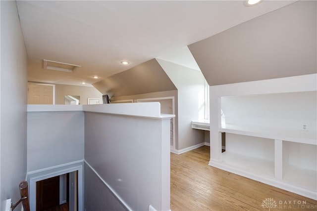 bonus room featuring lofted ceiling and light wood-type flooring