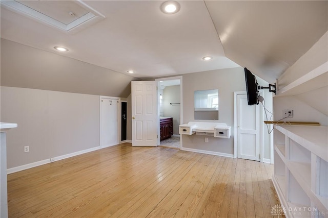 bonus room with light wood-type flooring and lofted ceiling