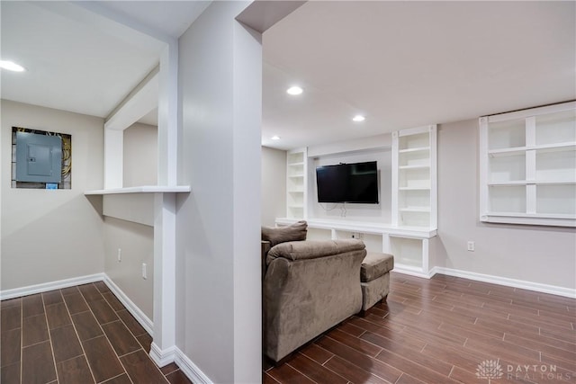 living room featuring electric panel and built in features