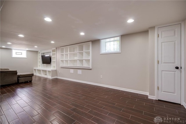 unfurnished living room with dark wood-type flooring