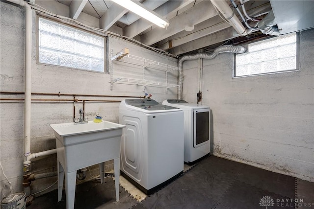 laundry area featuring separate washer and dryer and a healthy amount of sunlight