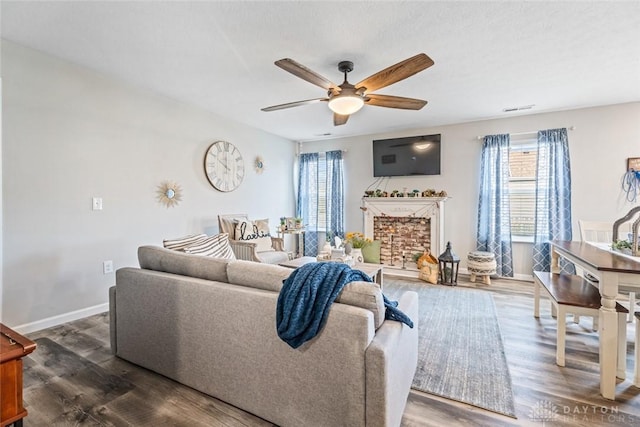 living room featuring ceiling fan and dark wood-type flooring