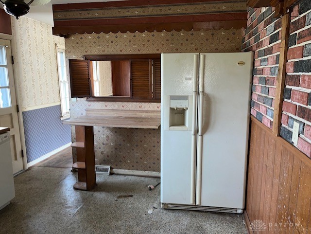 kitchen with white fridge with ice dispenser