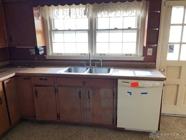 kitchen with dishwasher, plenty of natural light, and sink