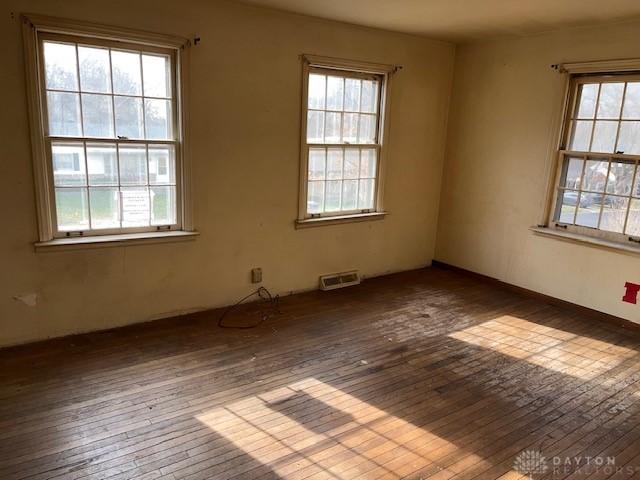 unfurnished room with hardwood / wood-style floors