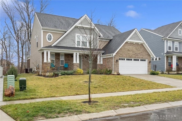 craftsman-style house featuring a garage, a front yard, and central AC