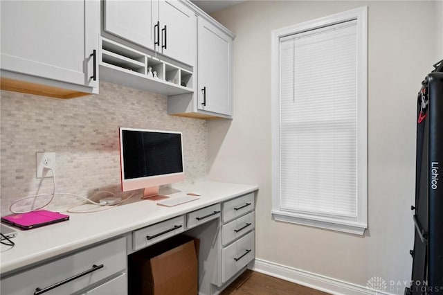 kitchen with tasteful backsplash and white cabinets